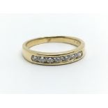 An 18ct yellow gold half eternity ring having a row of seven diamonds, approx 0.40ct, ring size