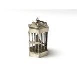 A small white metal bird cage enclosing a parrot, with sliding door, height approx 6cm