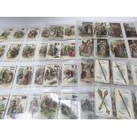 A collection of Salmon & Gluckstein cigarette cards