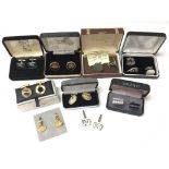 A collection of cuff links, some boxed