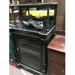 A Victorian ebonized and mirror backed pier cabinet with gilt brass mounts. 144cm x 82cm x 47cm.