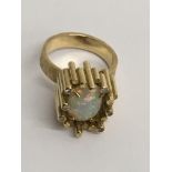 A 18 ct contemporary style gold ring inset with opal Size L . Total weight 12 grams