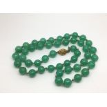 A Chinese green bead necklace.