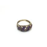 A 9ct gold ring set with amethyst coloured stones, approx 2.5g and approx size O-P.