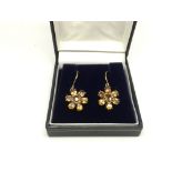 A pair of 9ct gold earrings set with zircons in a flowerhead design, approx 4.5g.