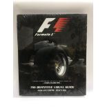 A sealed 'Formula One - The Definitive Visual Guide' hardback book with a ltd edition print signed