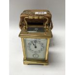 A leather cased French 4 glass brass carriage clock with enamel dial and alarm. 11.5cm.
