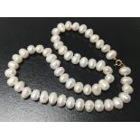 A cultured pearl necklace with 9ct gold clasps