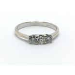 An 18ct white gold and three stone diamond ring, approx 0.33ct, ring size approx L/M