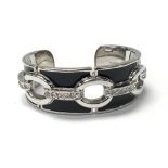 A Karen Millen cuff bangle with crystal chain decoration on black ground