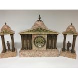 A Marble clock garniture with side ornaments with Corinthian columns the garniture of classical