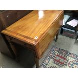 An Early Victorian mahogany Pembroke table the twin flap top with a rosewood banding on turned