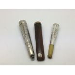 A silver cheroot holder in a silver case plus one other (2).