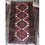 A red ground Persian rug, 157 x 80cm