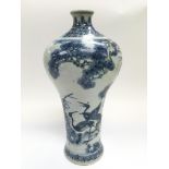 A 19th Century blue and white vase decorated with images of storks, approx height 29cm.