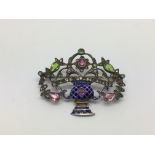 An antique silver and paste Giardinetto brooch set with coloured gemstones.