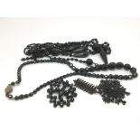 A collection of Victorian black glass jewellery.