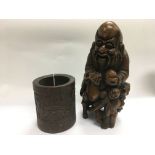 A carved wooden figure of an elder, approx height 30cm, together with a carved bamboo brush pot (