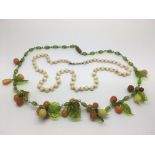 An antique glass necklace of fruit plus another pink bead necklace (2).