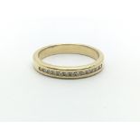 An 18ct yellow gold and diamond half eternity ring having a row of thirteen diamonds, ring size appr