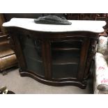 A Victorian mahogany credenza the serpentine marble top above a pair of glazed doors. 130 by 105