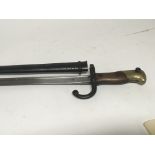 A French 1873 Gras pattern trefoil bayonet with a walnut brass caped grip steel scaboarded and