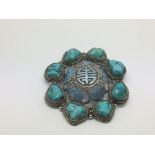 An antique Chinese silver and enamel brooch set with turquoise stones, approx 5cm diameter.