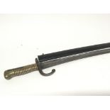 A French Quillion Bayonet with brass grip and black painted scabbard.