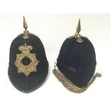 A late Victorian of Edwardian home service type military helmet and an old style police helmet