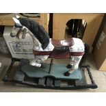 A small child’s hand painted rocking horse