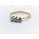 An 18ct yellow gold and three stone diamond ring, approx 0.15ct, ring size approx N