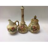 A collection of three Royal Worcester pieces comprising two vases and a jug decorated with flowers