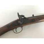 A 19th century Percussion Rifle walnut stock with brass fittings two rings and hinged ram rod. Total