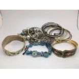 A collection of costume jewellery bangles and bracelets.