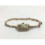 A vintage 9ct gold Art Deco ladies watch on a 9ct gold expanding bracelet. Glass is damaged but seen