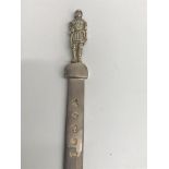 A solid silver paper knife the handle in the form of a Roman solider.