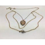 A 9ct gold chain and heart shaped locket plus one other.