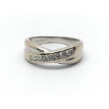 An 18ct white gold crossover ring with seven diamonds, approx 0.33ct, ring size approx O/P
