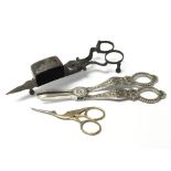 Three pairs of scissors consisting of a pair of c. 18th century candle wick trimmers, a pair of gilt