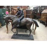 A large bronze figure of a horse and jockey on square base height 90 cm 64 cm wide