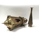An oriental style brass hanging lamp having six sides with glass panels and a brass Islamic vase