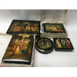 A collection of five Russian boxes finely painted with various scenes.