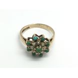 A 9ct gold ring set with seed pearls and green stones, approx 2.9g and approx size N-O.