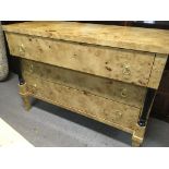 An empire style maple chest fitted with three drawers on splayed legs .