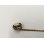 A Edwardian stick pin inset with pearl and old cut diamonds.