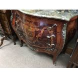 A French style Inlaid commode the serpentine marble top above four drawers with ormolu mounts 90
