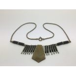 An Art Deco metal and phenolic necklace attributed to Jakob Bengel.