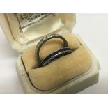 A sapphire eternity ring size k and a diamond eternity ring size L