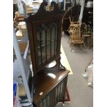 A Edwardian inlaid corner cabinet the swan neck above a single glazed door . Above two oval