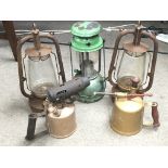 Two vintage blow lamps, an old Tilley lamp and two Victorian hurricane lamps